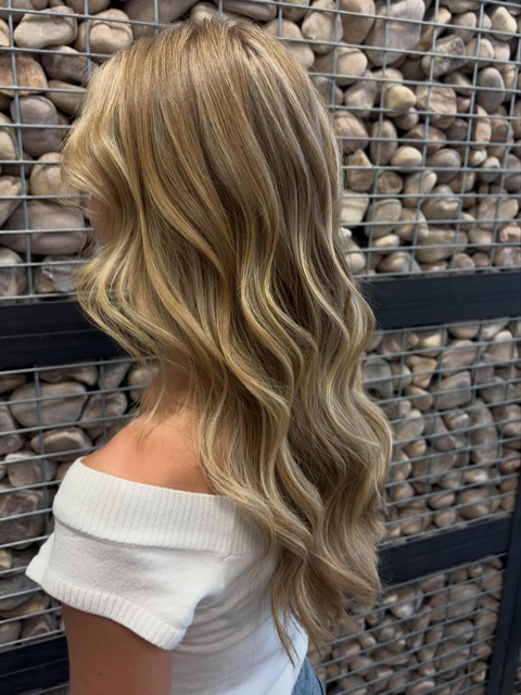 Long blonde highlights and loose waves styled by Kamryn