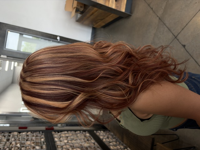 Dimensional copper color and curls styled by Kamryn